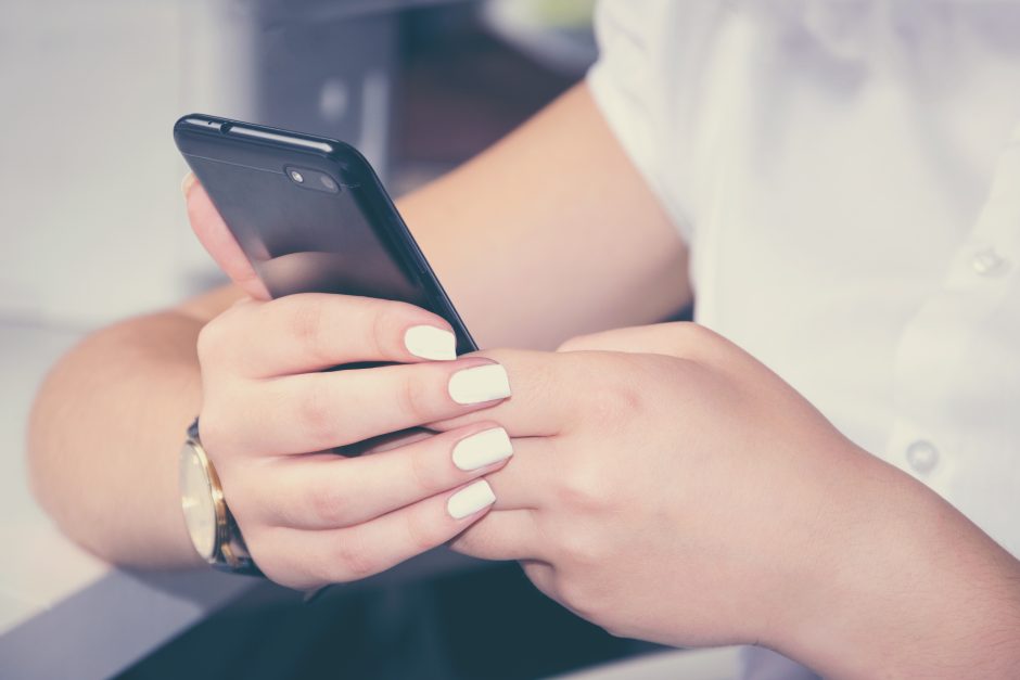 Young woman on her phone contacting Conqueror for support